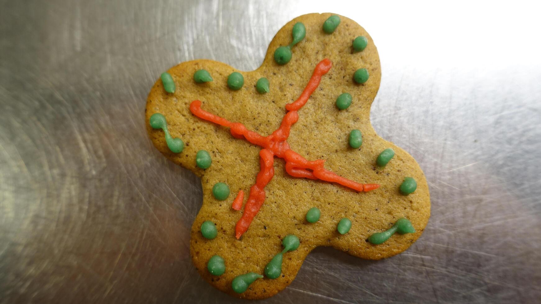 Ginger cookie in the shape of a colorful four leaf clover photo