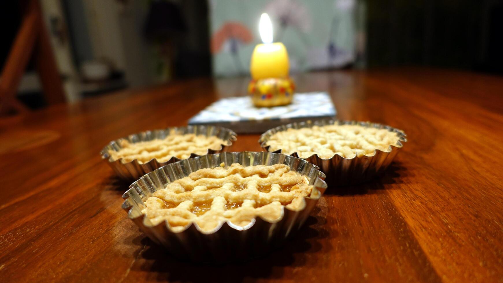 Traditional Easter cakes and a lit egg-shaped candle to wish everyone a happy Easter photo