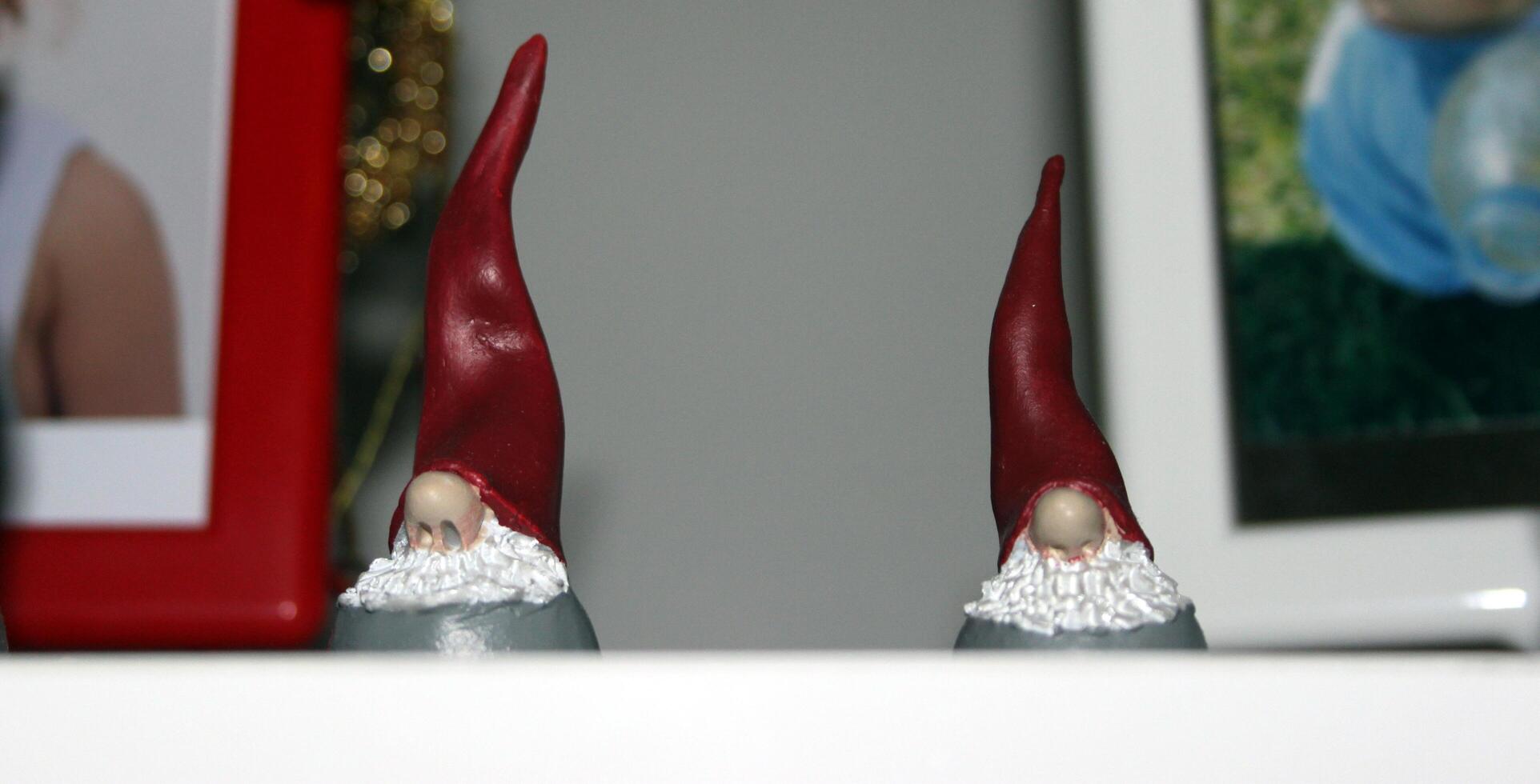 two small statues of two elves dressed in red photo