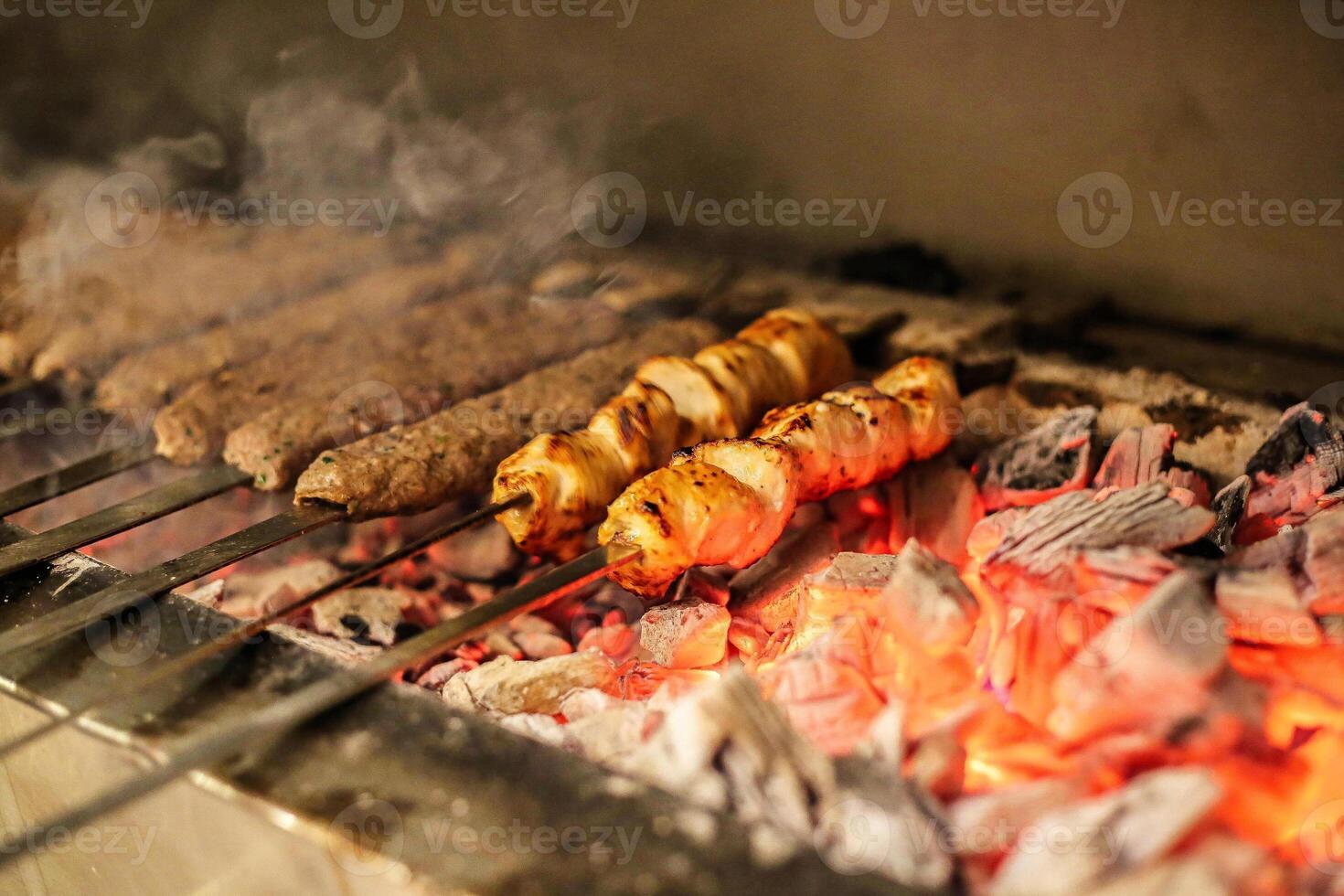 Grilled Hot Dogs and Sausages Cooking on the Grill photo