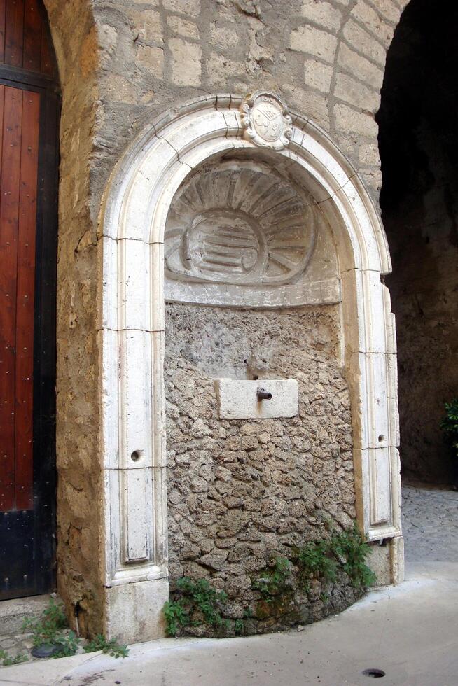 Santa Agata de Goti, Italy, Europe - July 21, 2019. an ancient fountain in disuse photo