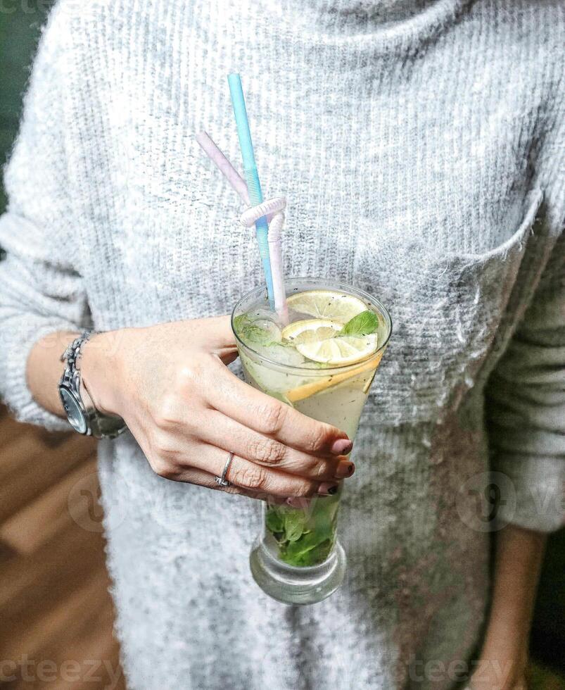 Woman Holding a Beverage Drink at a Social Gathering. photo