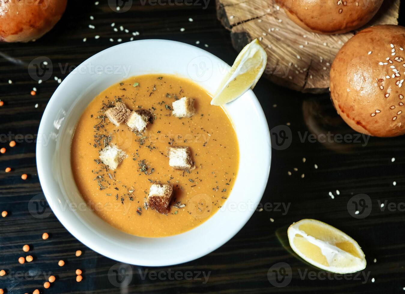 Bowl of Soup With Bread on the Side photo