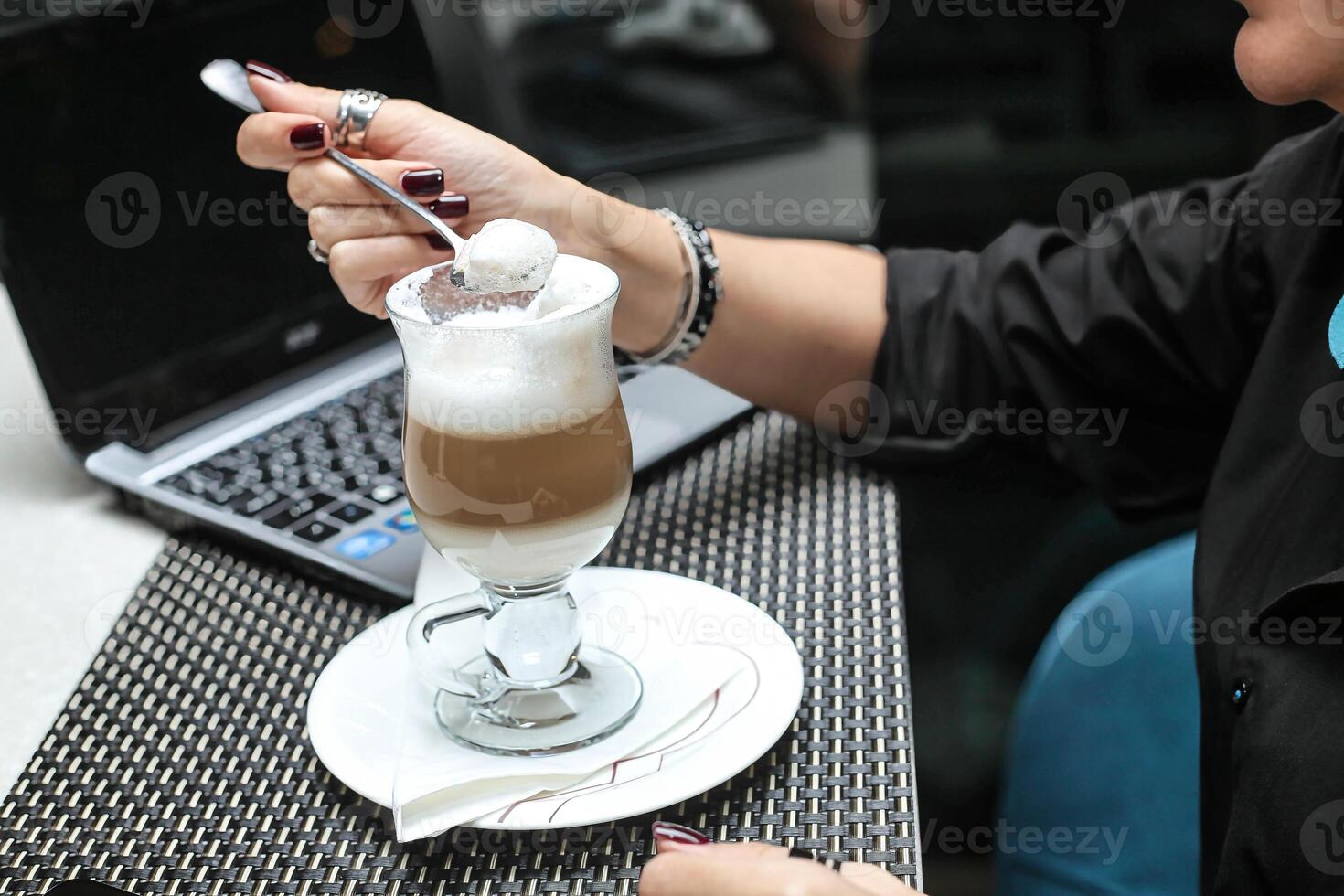 Woman Sitting at Table Using Cell Phone photo
