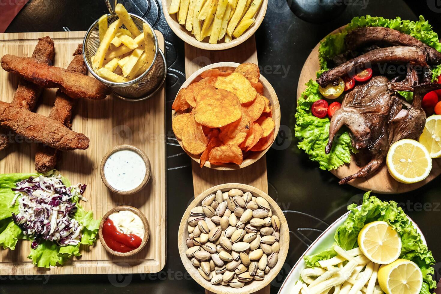 Table With Plates of Food and Bowls of Fries photo