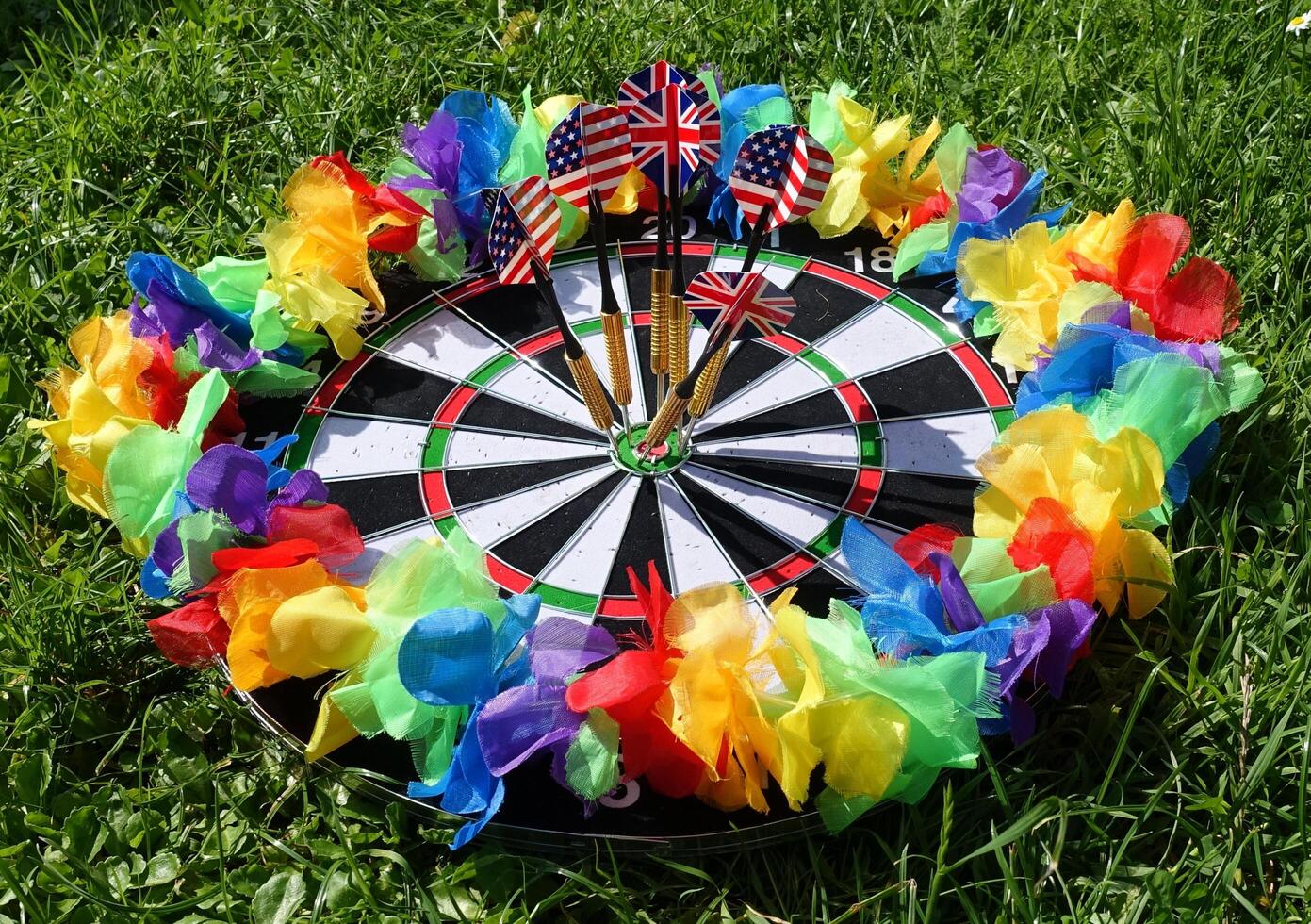 dartboard with a lgbt colored garland around it photo