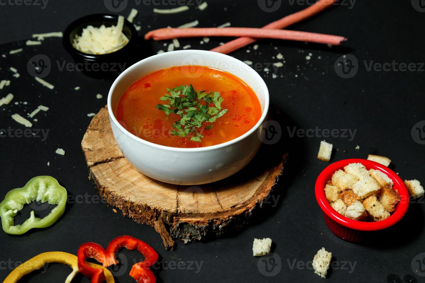 Bowl of Tomato Soup on Wooden Board photo