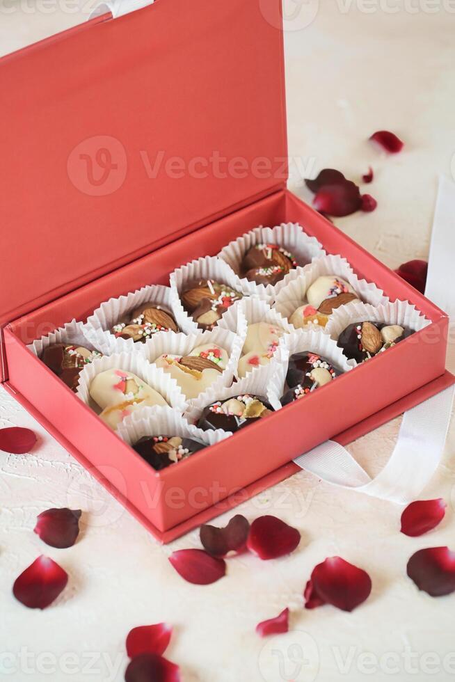 Red Box Filled With Chocolates on Table photo