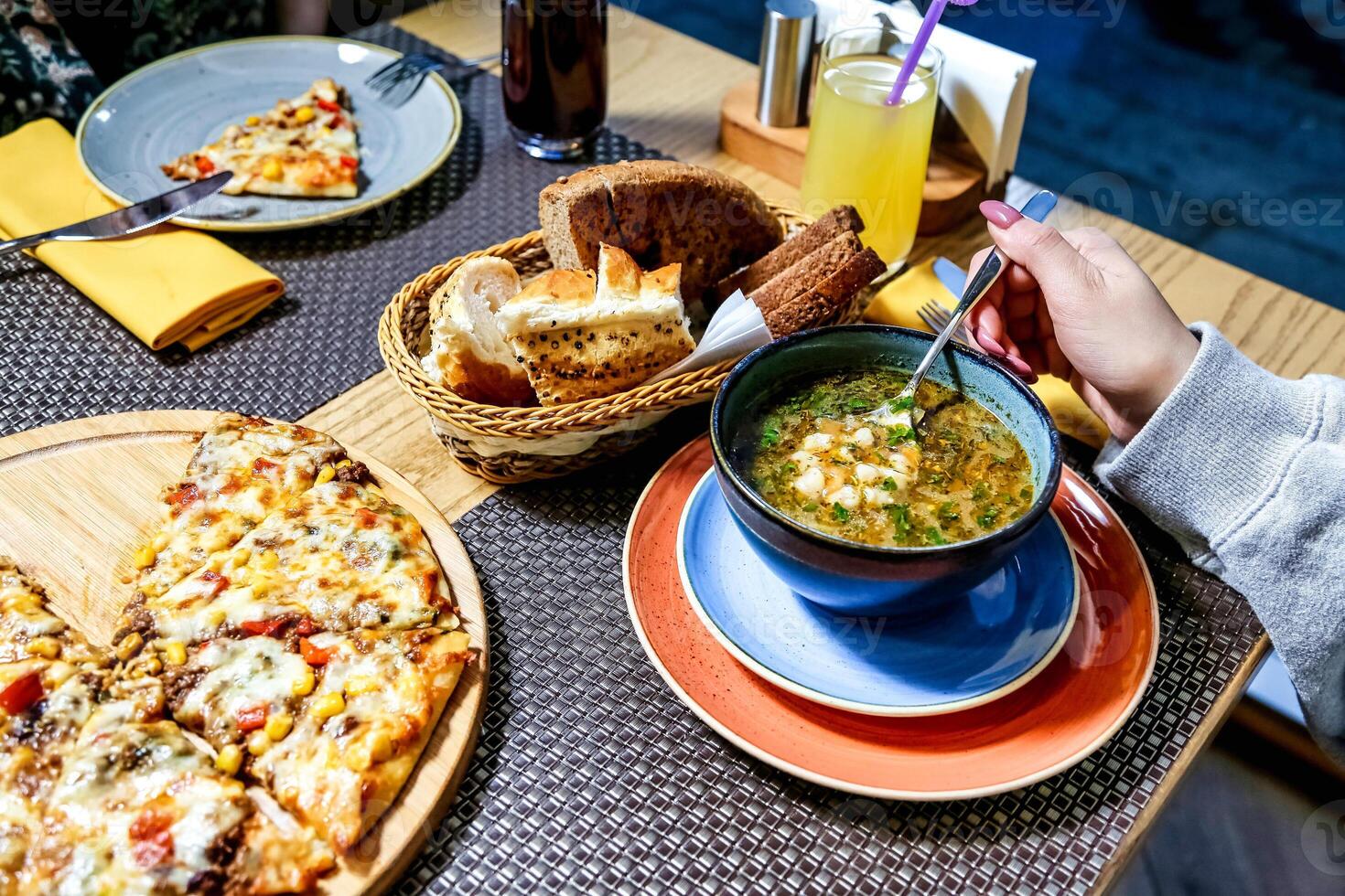 Table With Plates of Food and Bowl of Soup photo
