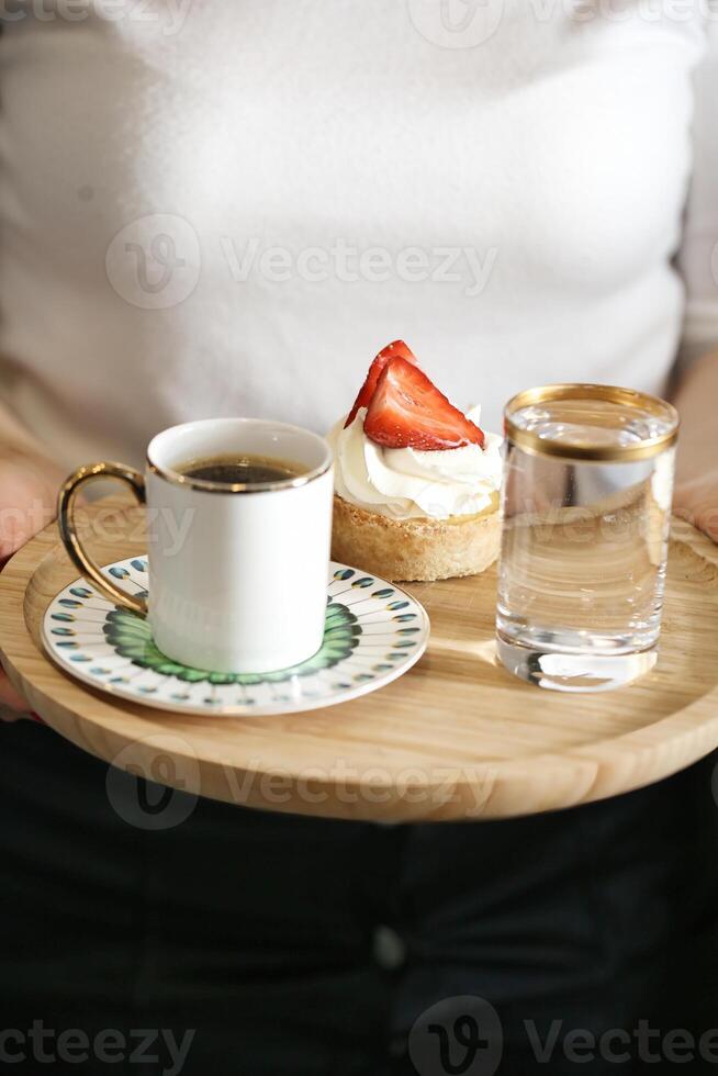 Person Holding Tray With Coffee Cup and Strawberry photo