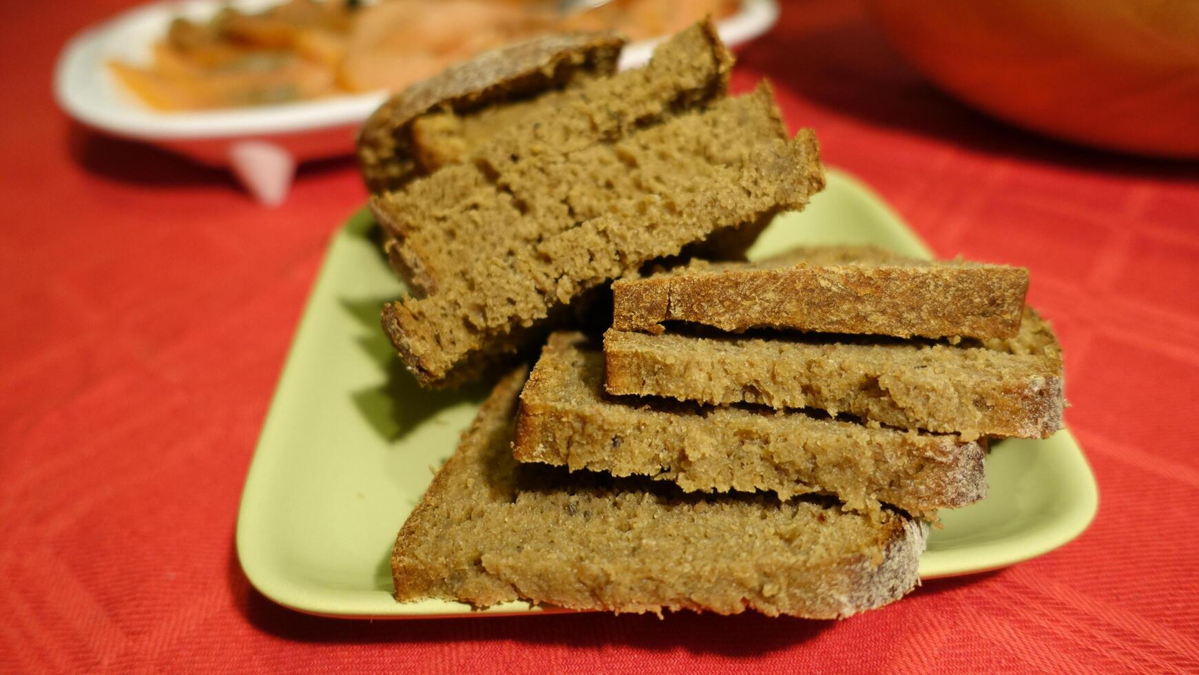 Sliced vort bread served on a green saucer photo