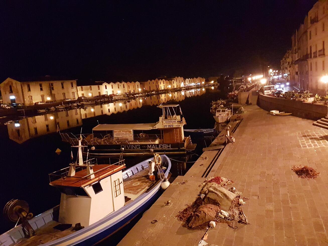 Bosa, Sardinia, Italy, Europe - August 12, 2019 the small port of Bosa during the night photo