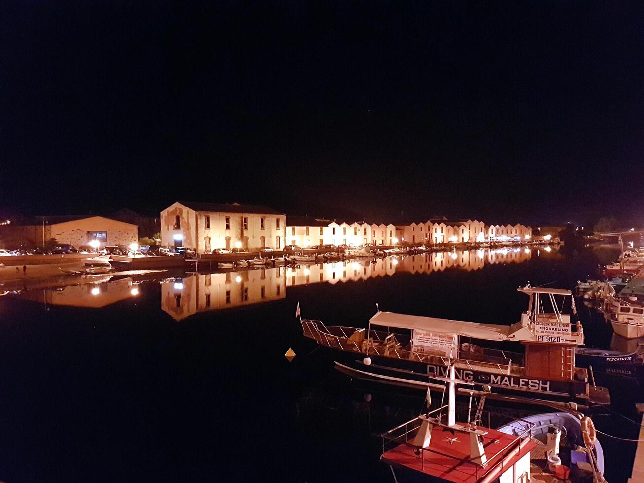 Bosa, Sardinia, Italy, Europe - August 12, 2019 the small port of Bosa during the night photo