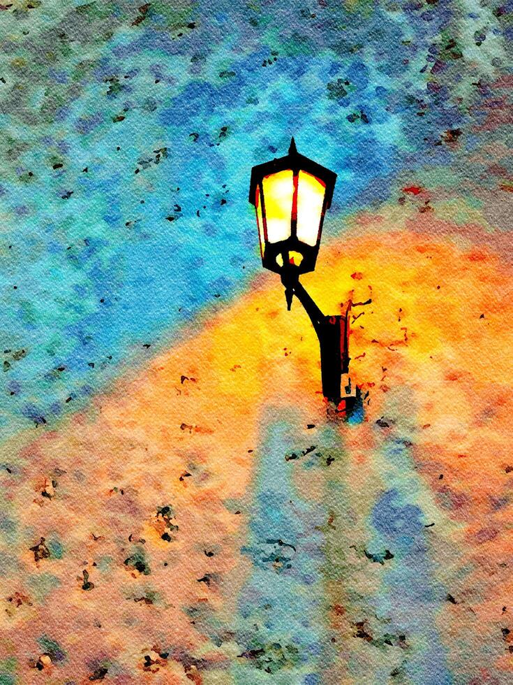 An ancient illuminated wall lamp in the alley of an old town photo