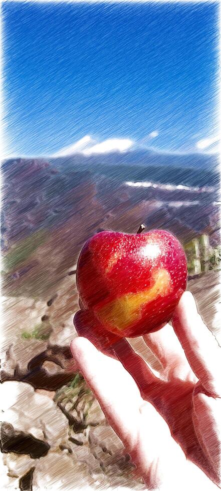 A ripe apple on the fingers of one hand with the landscape in the background. photo