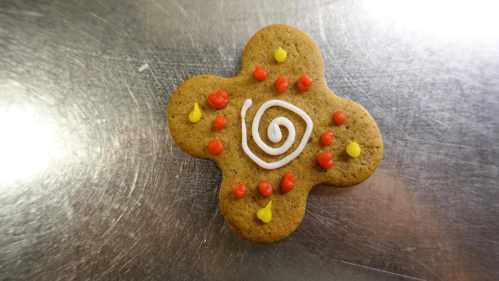 Ginger cookie in the shape of a colorful four leaf clover photo