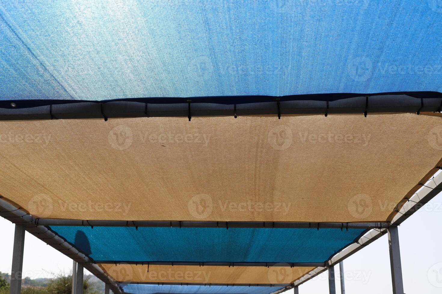 Canopy for protection from the hot sun in a city park. photo