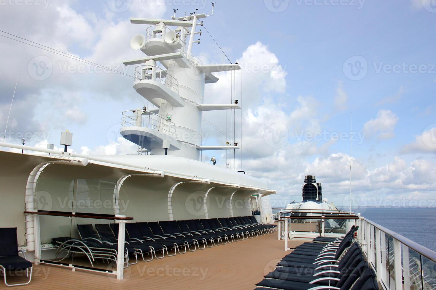 On the upper deck of a large ocean liner. photo