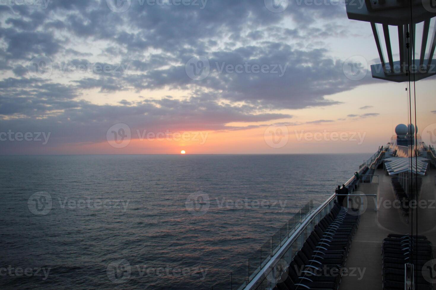 On the upper deck of a large ocean liner. photo