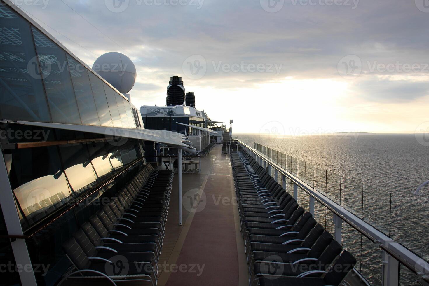 On the upper deck of a large ocean liner. photo