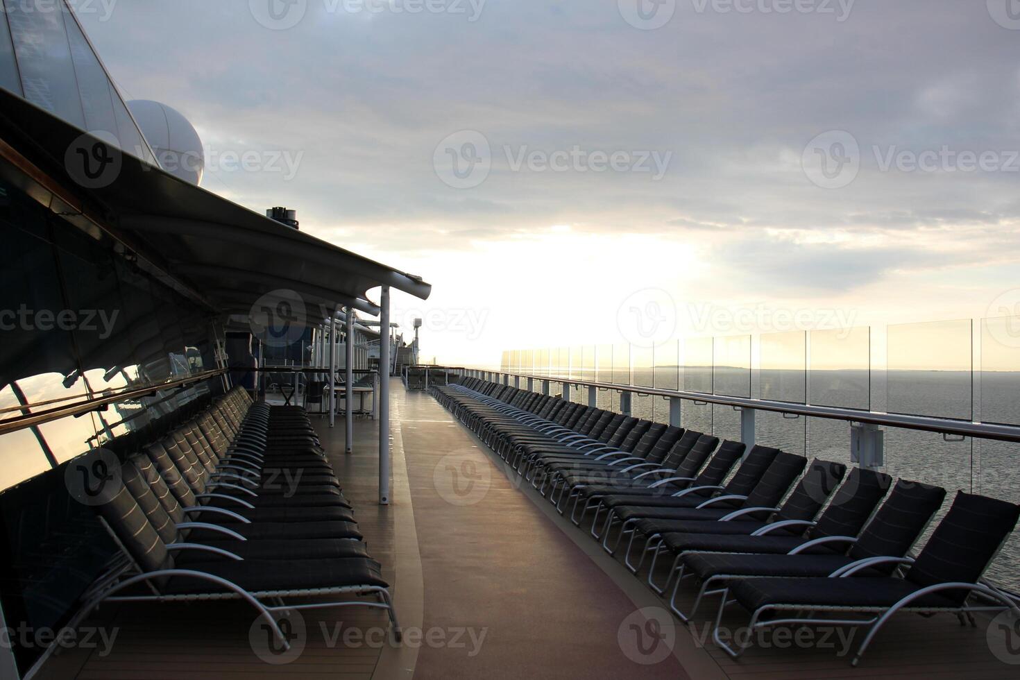 On the upper deck of a large ocean liner. photo