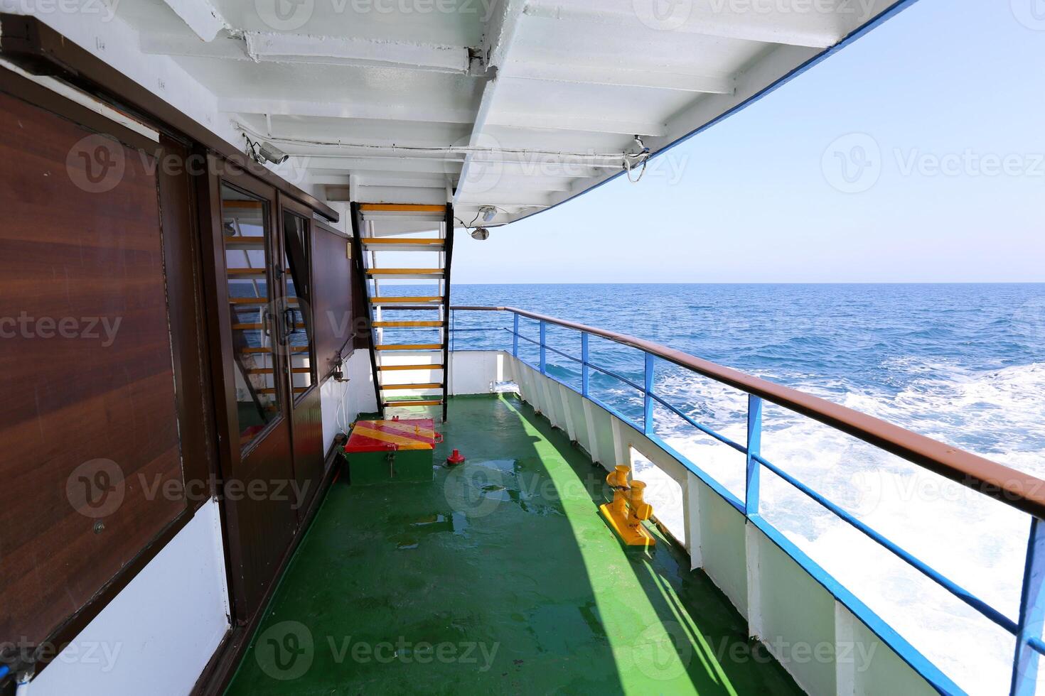 On the upper deck of a large ocean liner. photo