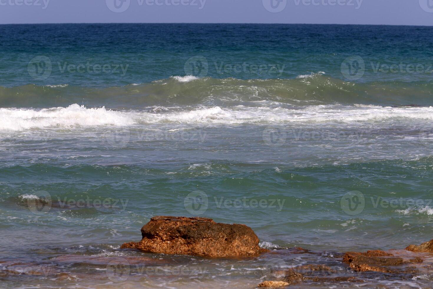 Stones and shells on the shore of the Mediterranean Sea. photo
