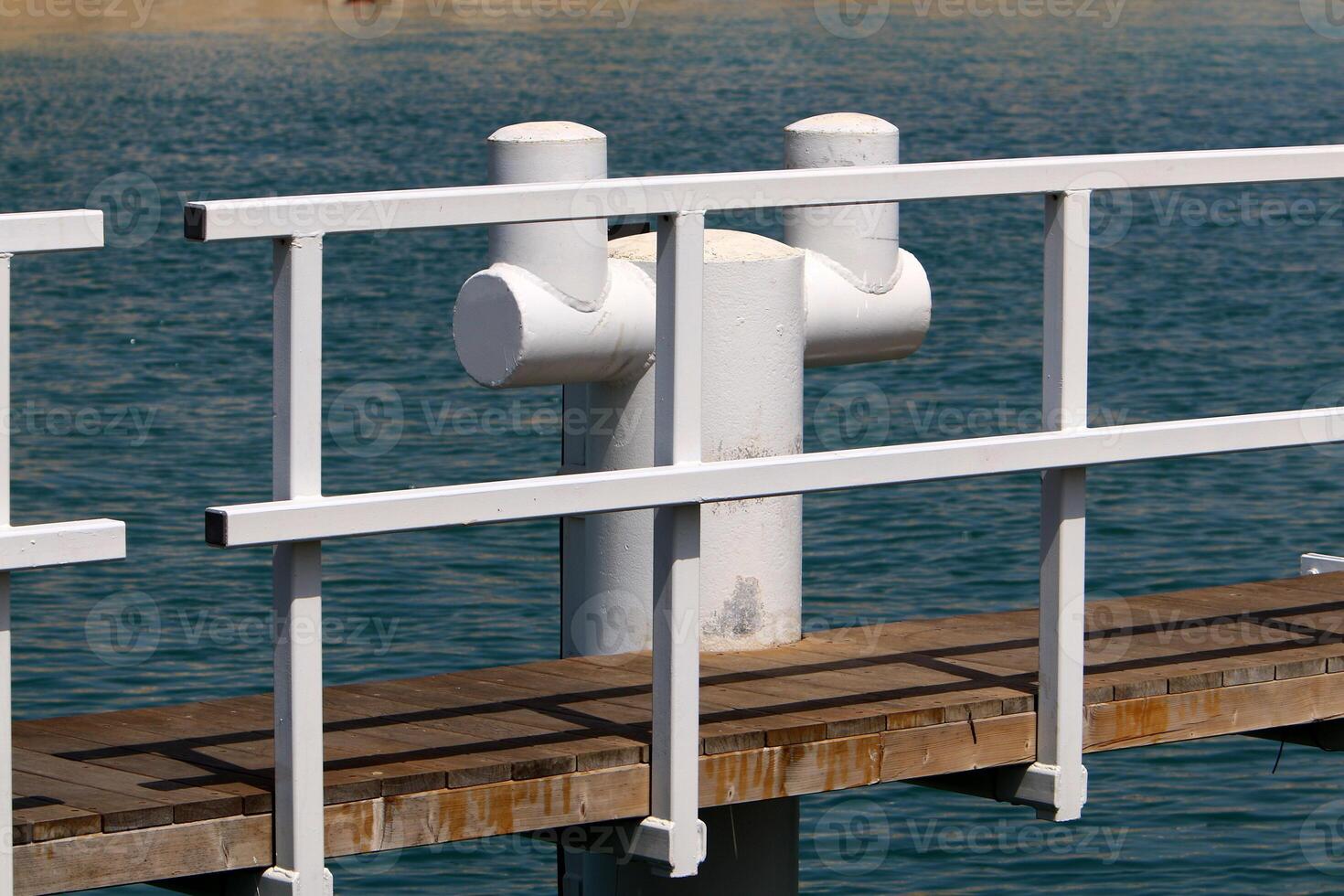 A pier on the shore for mooring boats and yachts. photo