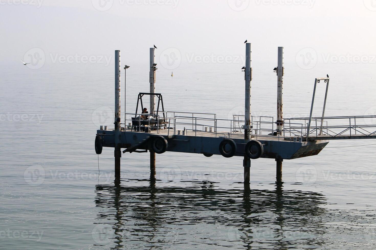 A pier on the shore for mooring boats and yachts. photo