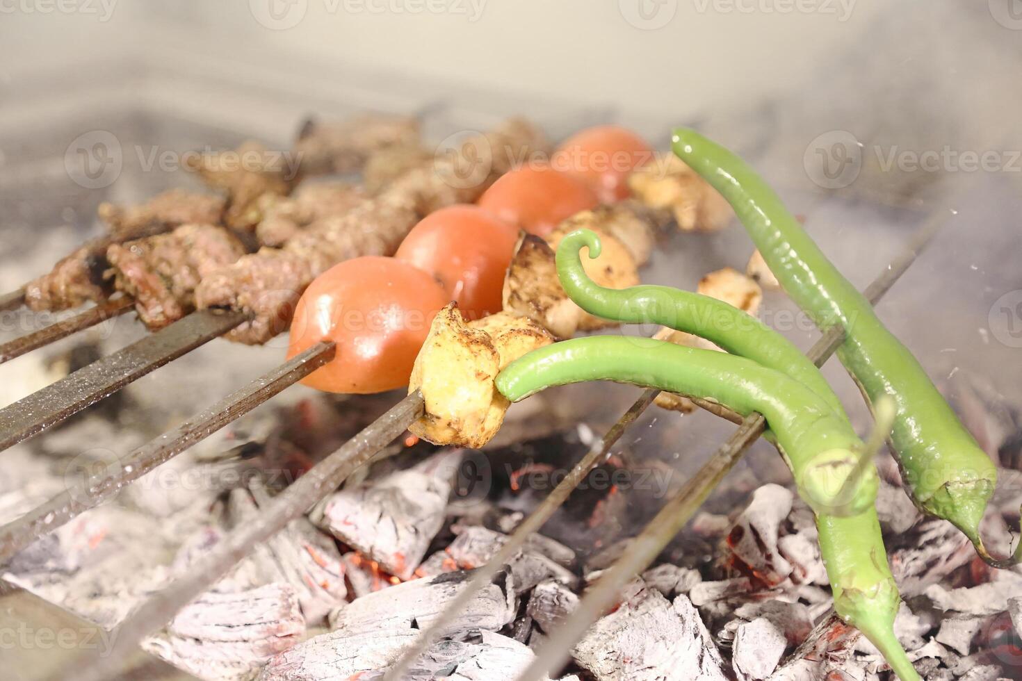 Various Foods Cooking on an Outdoor Grill photo