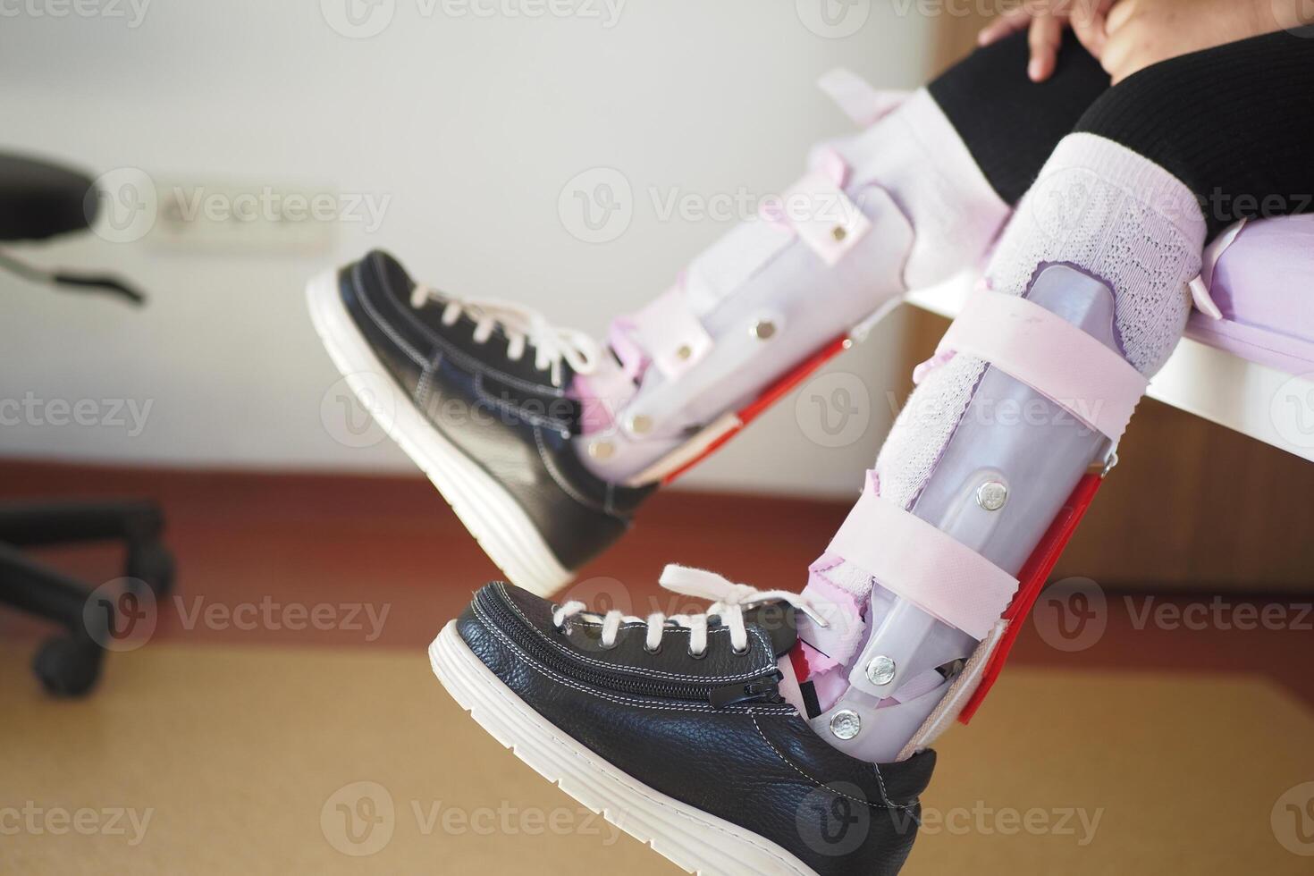 Child cerebral palsy disability, legs orthosis. photo