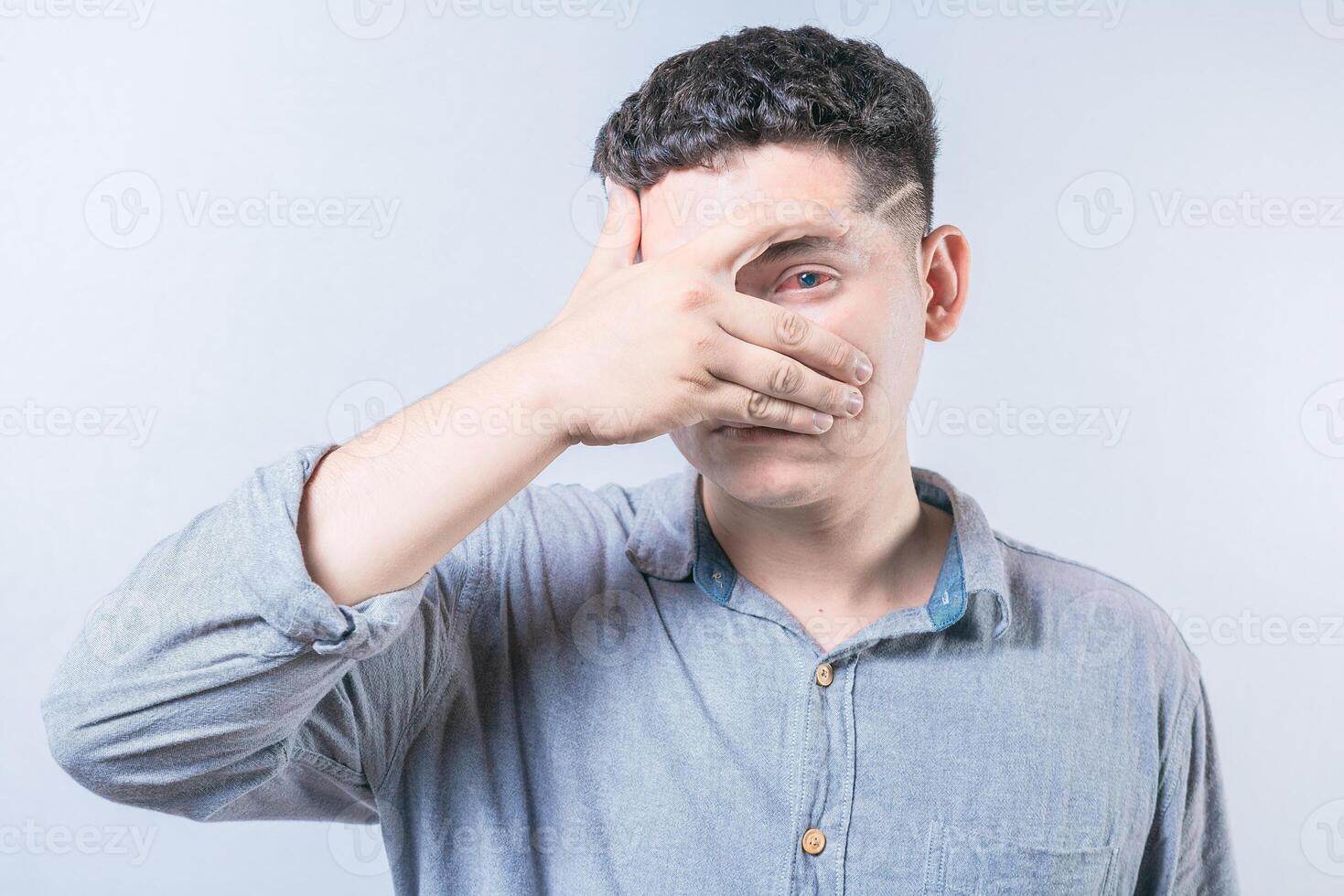 Young person with irritated eyes. People with conjunctivitis covering eye isolated. Man with eye infection isolated photo