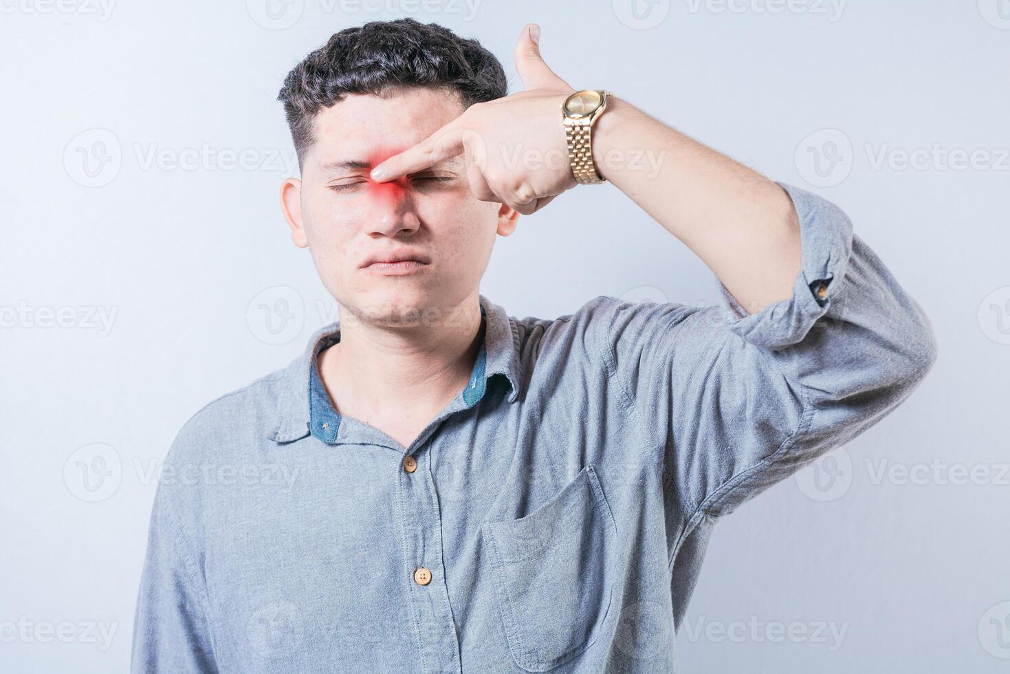 Man with nasal bridge pain isolated. Person with pain touching nose. Guy suffering with nasal bridge headache photo