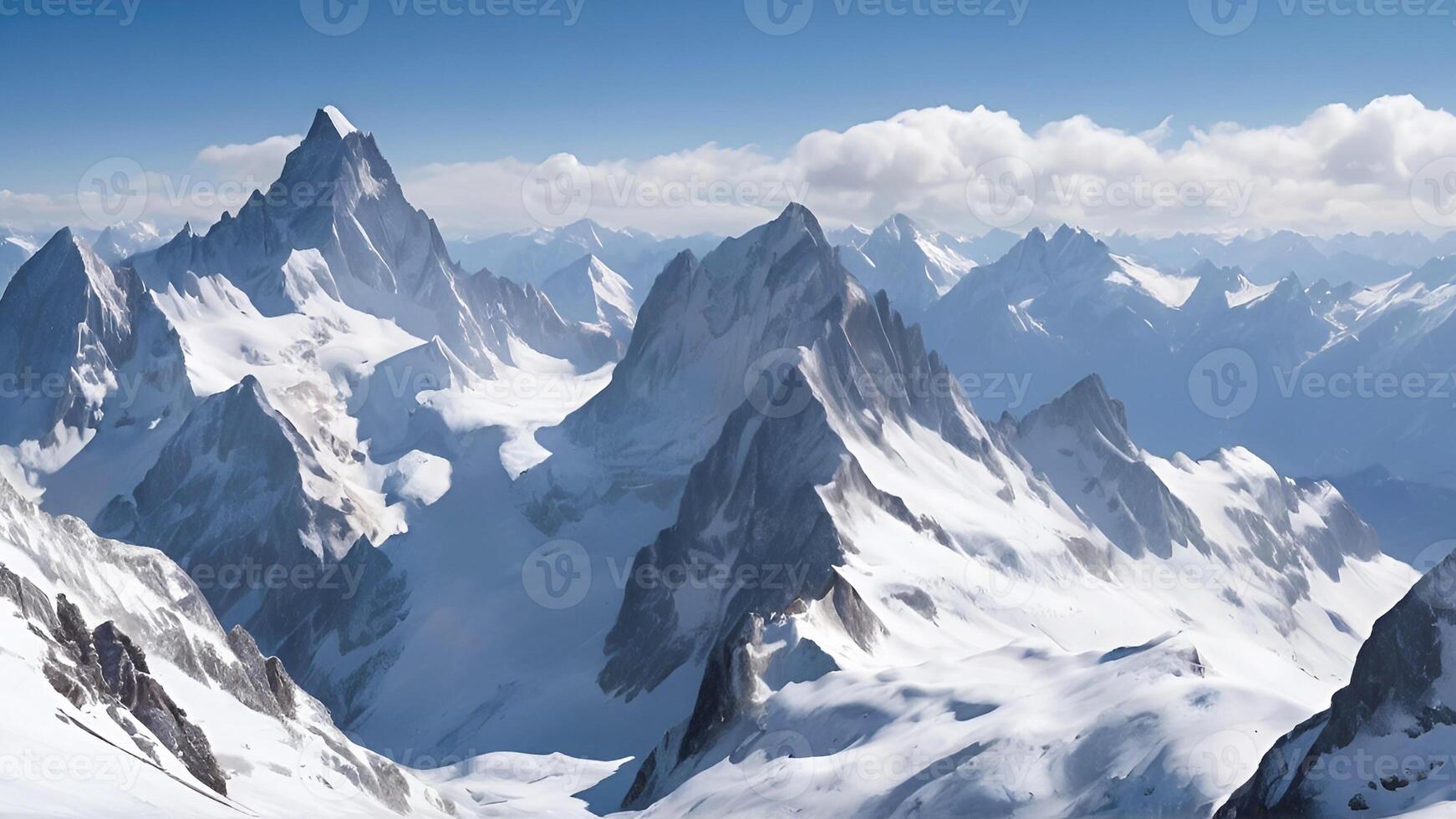 Breathtaking Panoramic View of Snow Capped Mountain Peaks Under a Clear Blue Sky photo