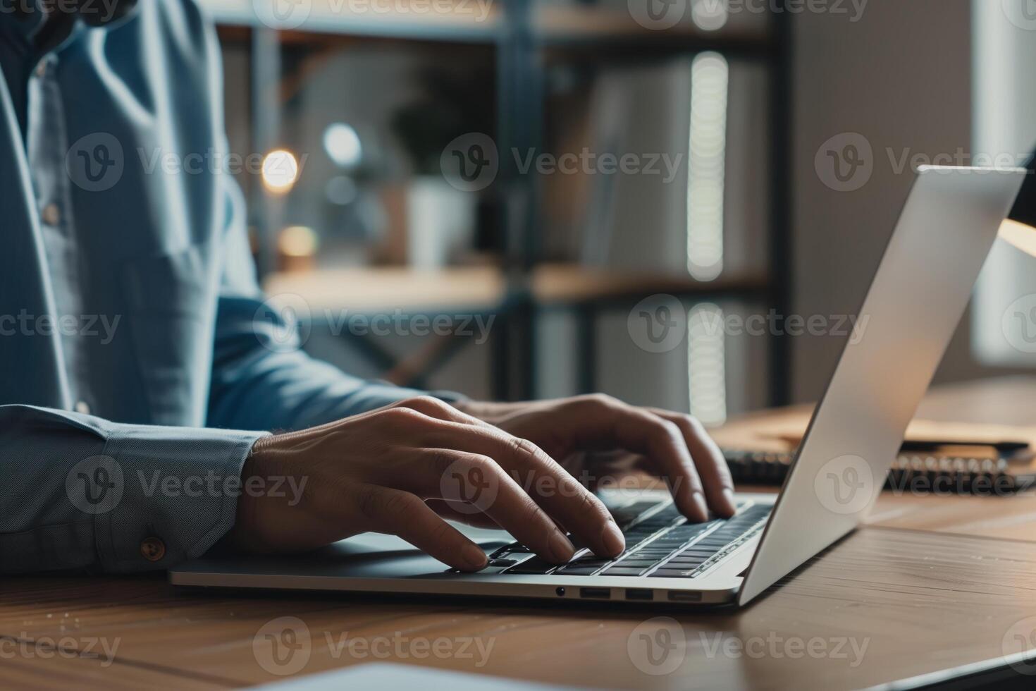 Corporate businessman in suit working on laptop in his office photo