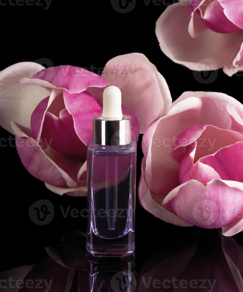 a bottle of perfume with a pink flower photo