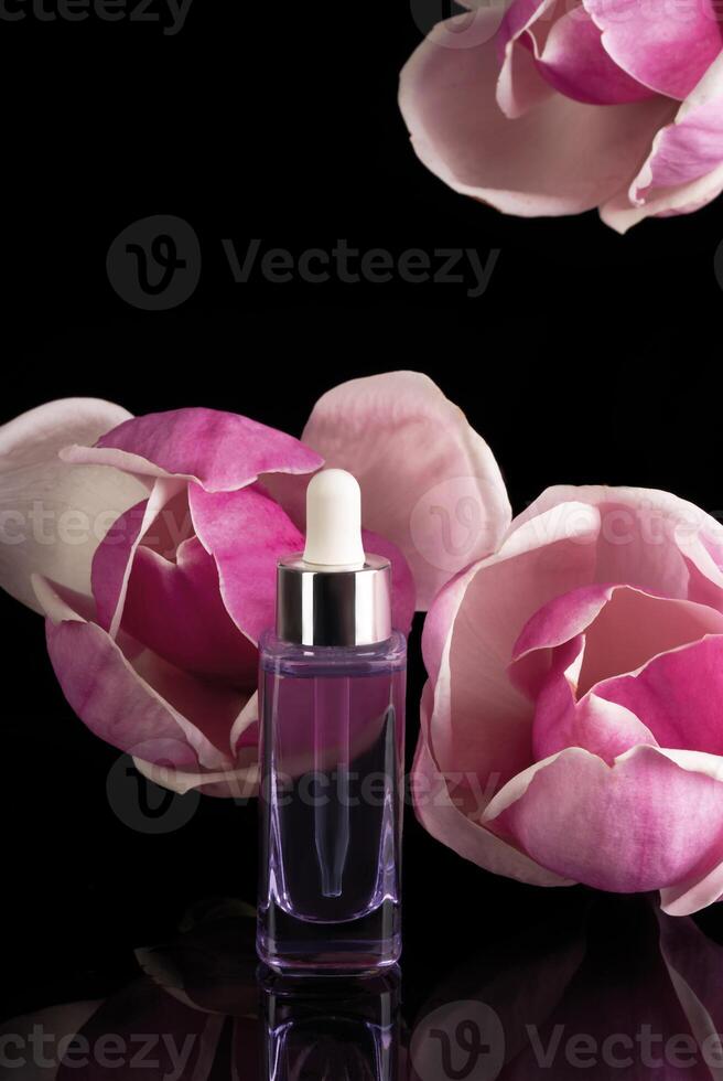 a bottle of perfume with a pink flower photo