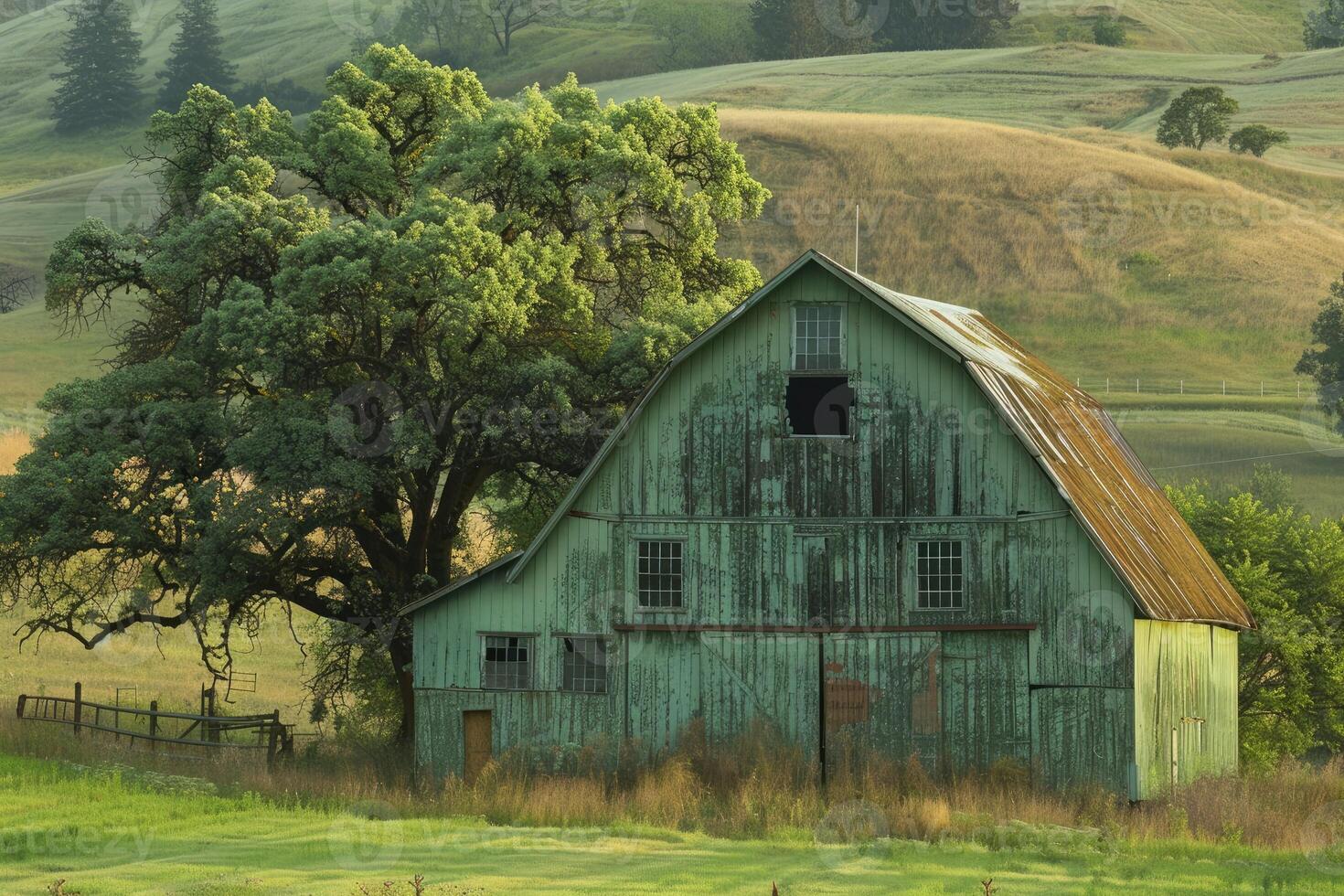 Vintage rustic barn in grassy field photo