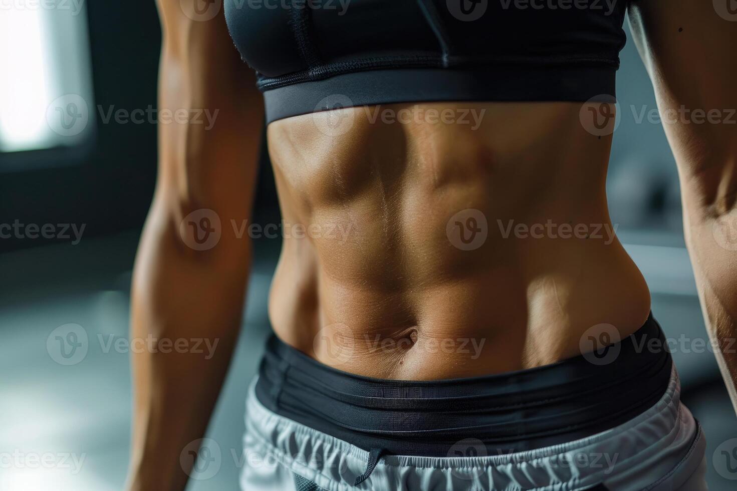 Close-up of the abdominal muscles young athlete in gym photo