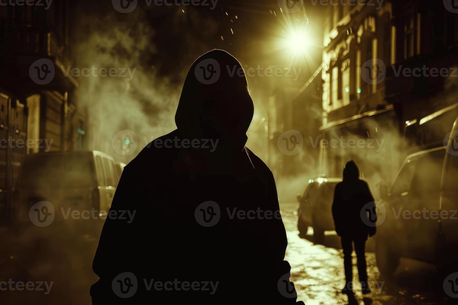 Dangerous criminal. Silhouette of bandits, criminals with an unrecognizable face in threatening pose at night on dark street. photo