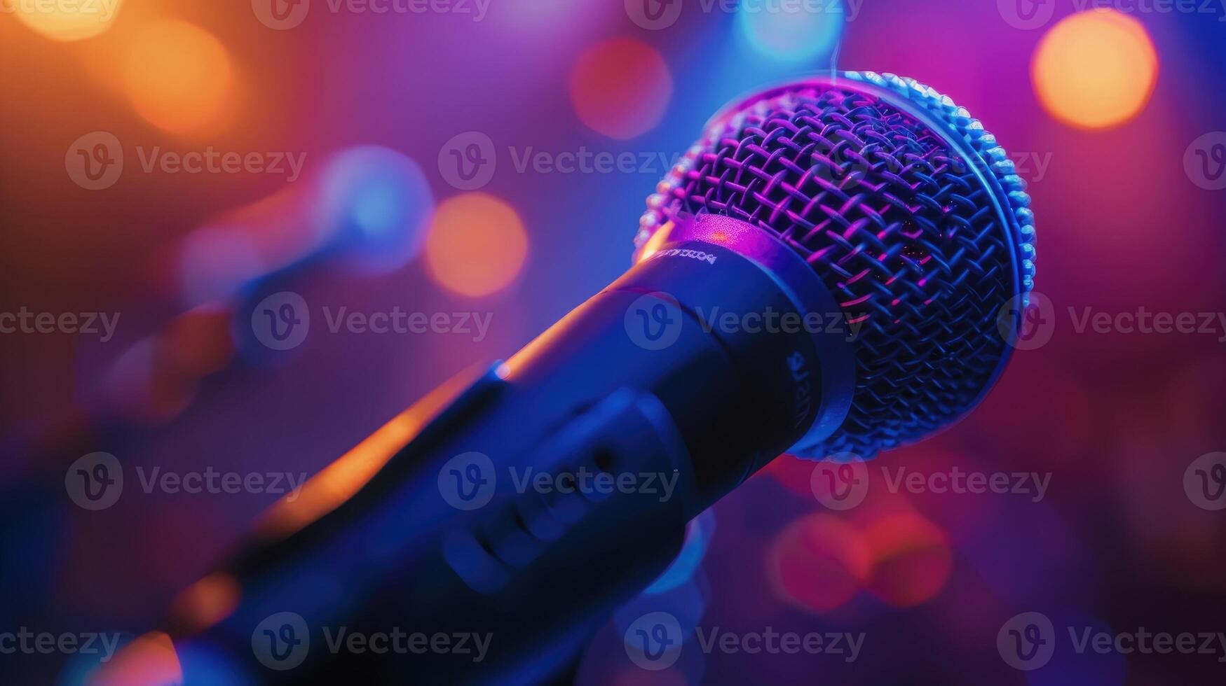 Modern professional microphone in a recording studio. Close up of microphone on stage with purple light. photo