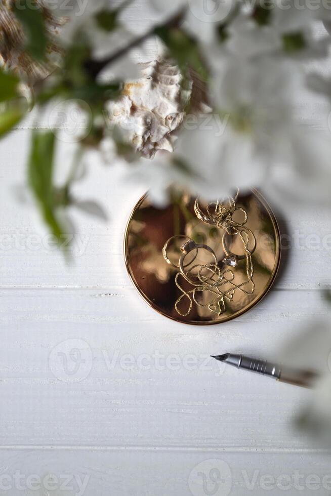 Golden accessories and pen, close up. photo