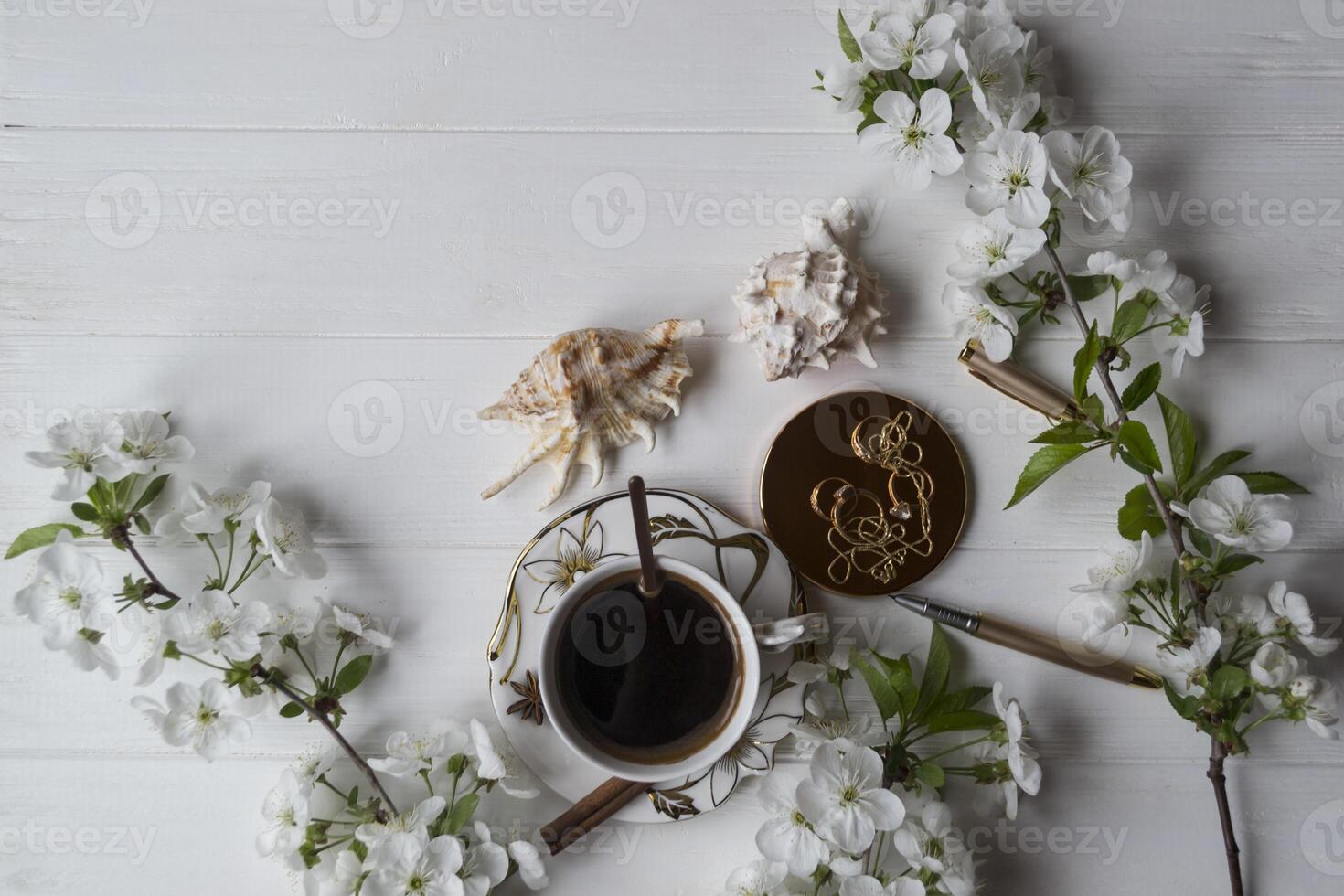 A cup of coffee and blossom branches. Spring morning. photo