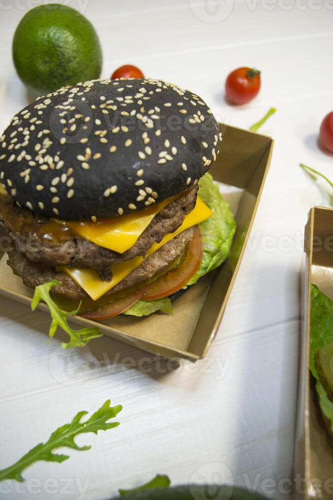 Black burger on the table. photo