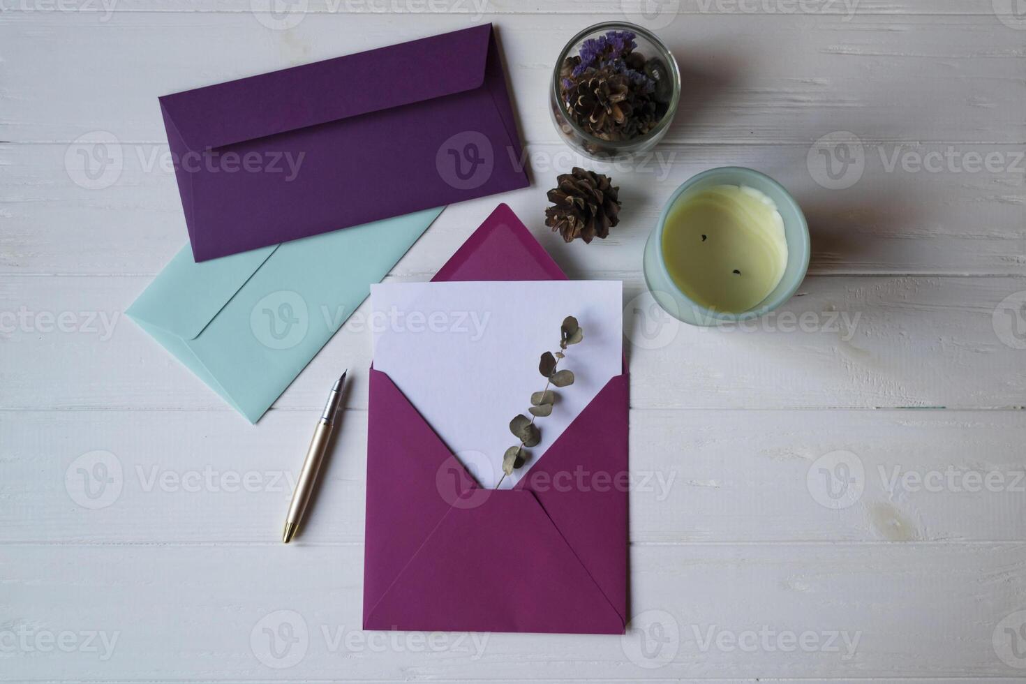 The pink envelope with note blank on the white wooden table. Beautiful desktop. Background with place for text. photo