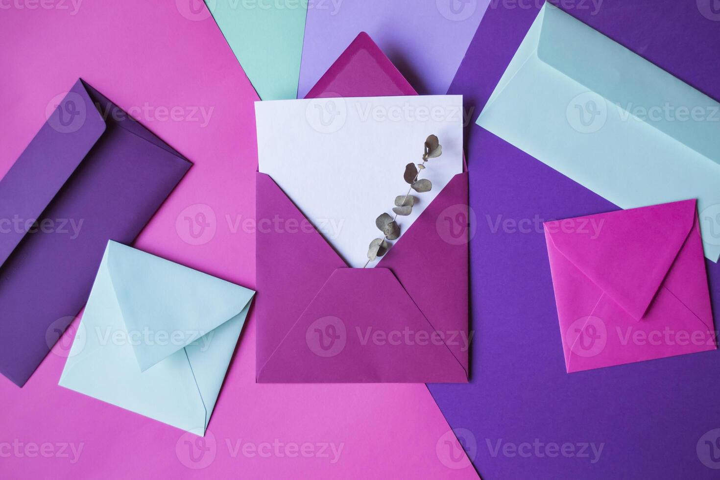 The pink envelope with note blank on a colorful background. photo