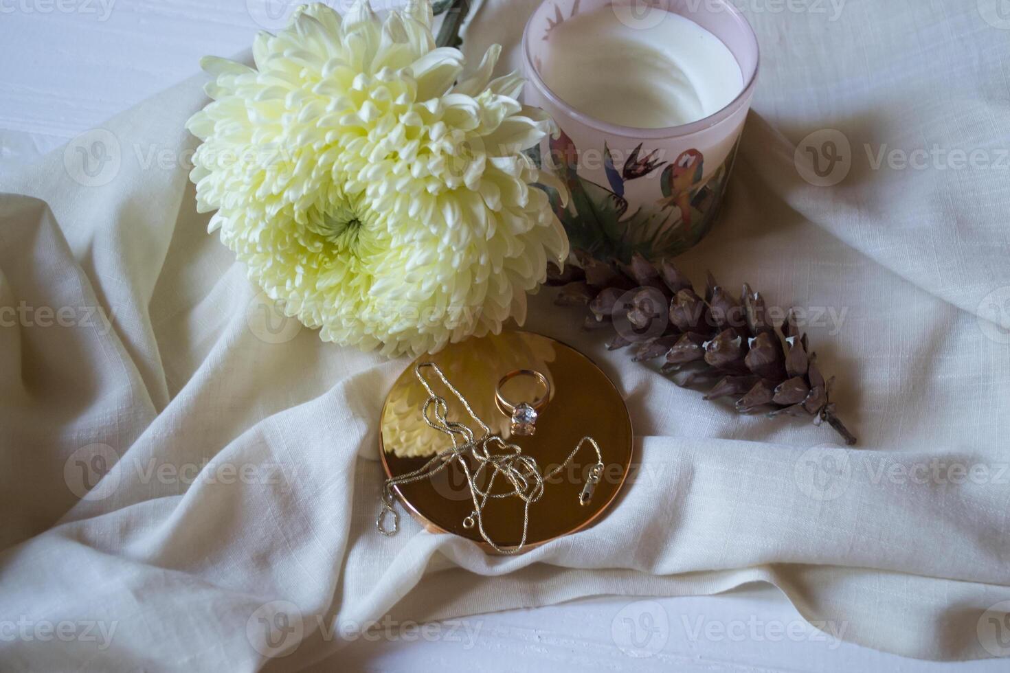 The golden chain and ring with diamond near flower, close up. photo