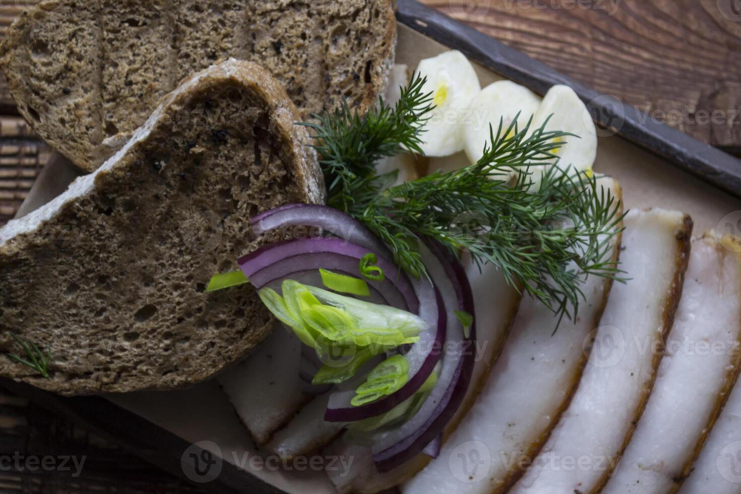 The sliced lard with bread and spices. photo