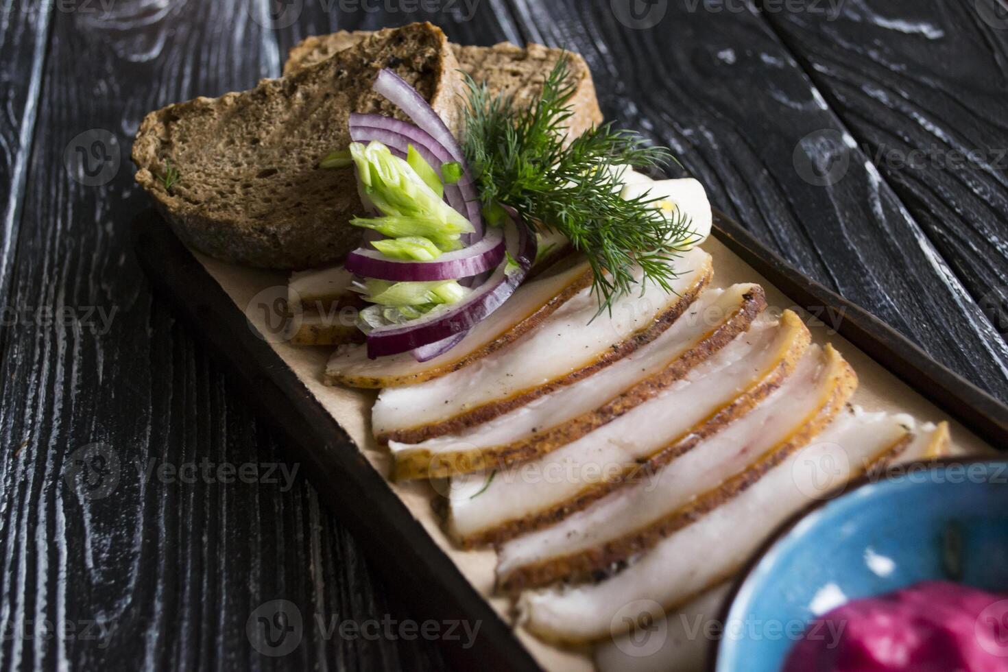 The sliced lard with bread and spices. photo