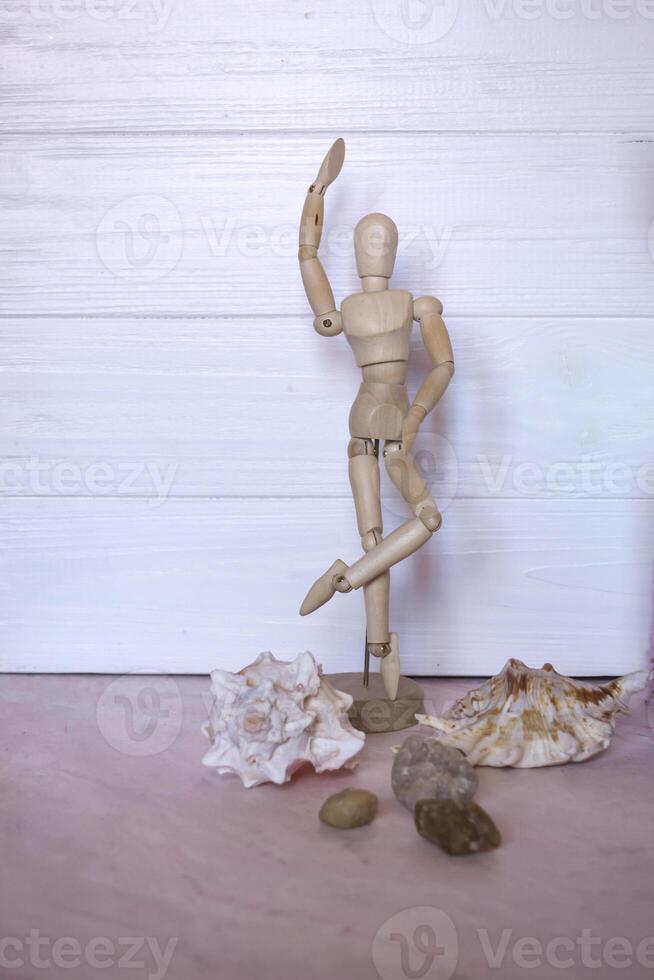 Wooden mannequin for drawing on a table. photo